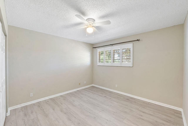 unfurnished room featuring ceiling fan, light hardwood / wood-style flooring, and a textured ceiling