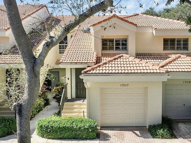 mediterranean / spanish house with a garage