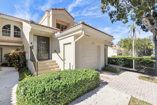 doorway to property with a garage