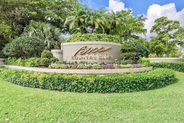 community / neighborhood sign featuring a lawn