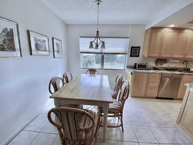 tiled dining area featuring a chandelier, sink, and a textured ceiling