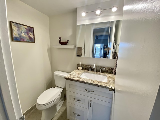 bathroom featuring toilet and vanity