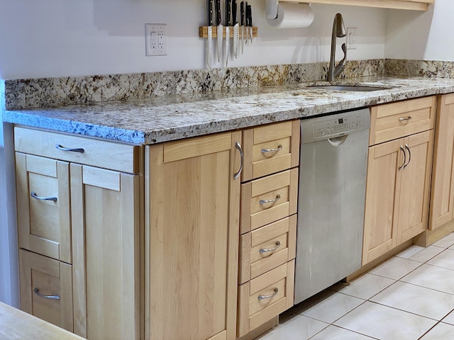 kitchen with dishwasher, light stone countertops, sink, and light brown cabinets