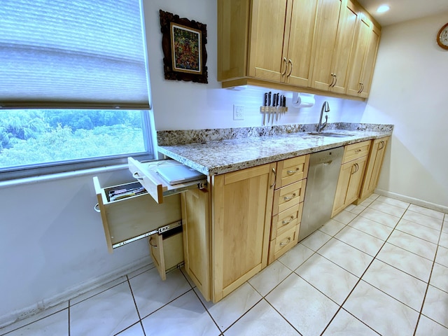 kitchen with stainless steel dishwasher, sink, and light brown cabinets