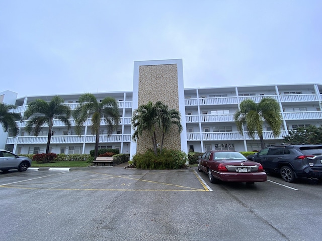 view of building exterior featuring uncovered parking