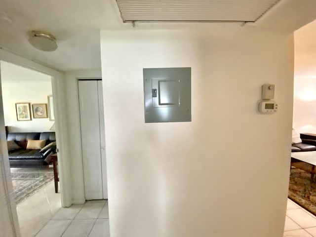 hallway with light tile patterned floors and electric panel