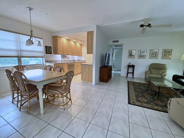 dining room featuring ceiling fan, visible vents, a textured ceiling, and light tile patterned flooring