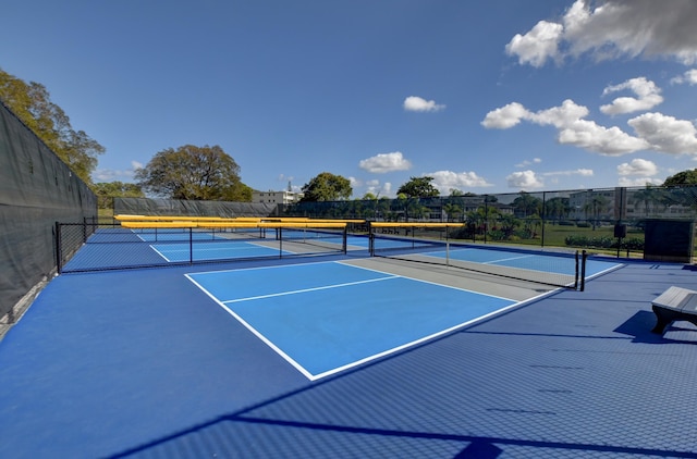 view of tennis court featuring fence