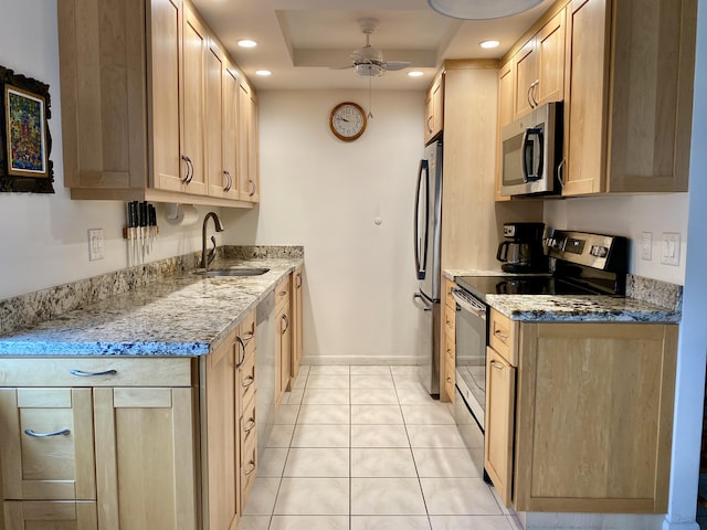 kitchen with recessed lighting, a sink, a ceiling fan, appliances with stainless steel finishes, and light stone countertops