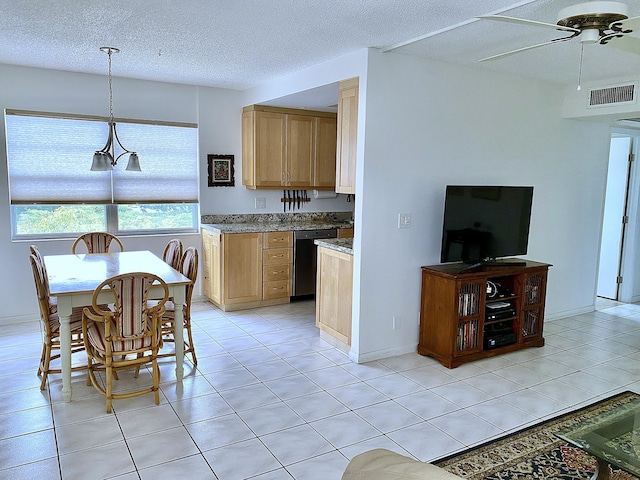 kitchen featuring pendant lighting, dishwasher, light tile patterned floors, ceiling fan, and a textured ceiling