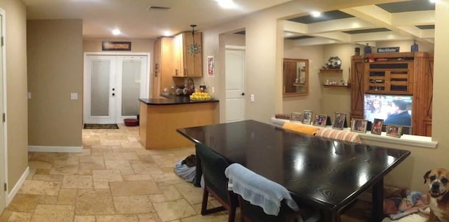 kitchen featuring a breakfast bar area, kitchen peninsula, and french doors