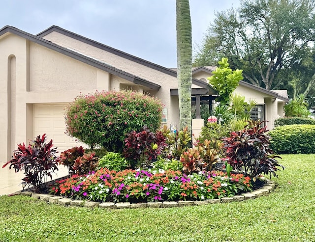 view of side of home with a garage and a yard