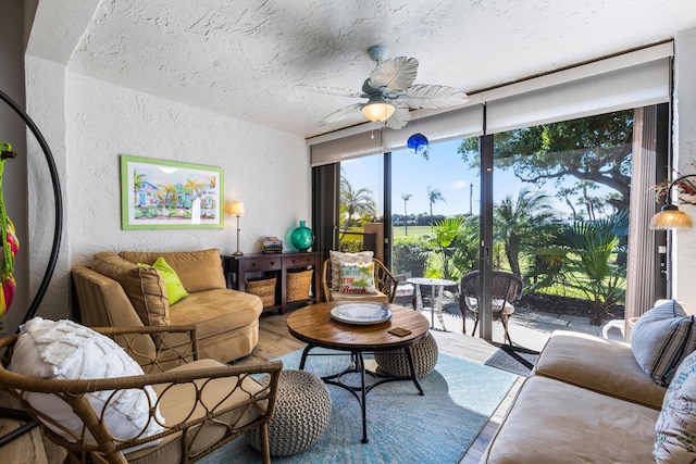 living room featuring hardwood / wood-style flooring, expansive windows, and ceiling fan