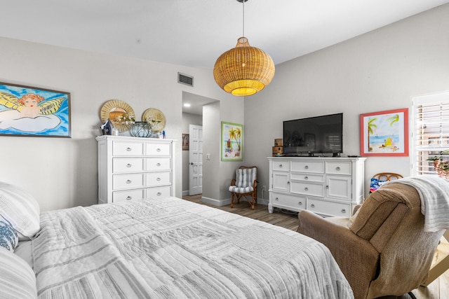 bedroom with dark hardwood / wood-style flooring