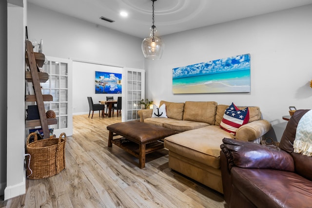 living room featuring french doors and light hardwood / wood-style flooring