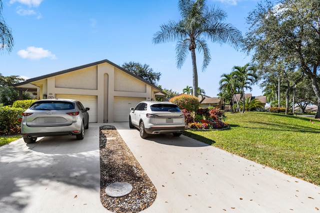 view of front of house featuring a garage and a front lawn