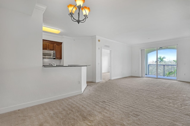 unfurnished living room with an inviting chandelier, ornamental molding, sink, and light carpet