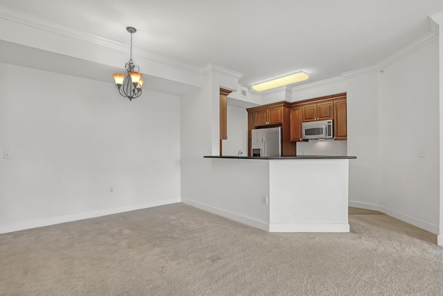 kitchen with decorative light fixtures, ornamental molding, kitchen peninsula, stainless steel appliances, and light carpet