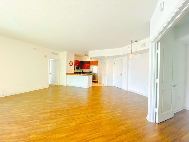 unfurnished living room with light wood-type flooring