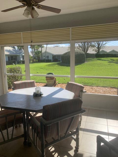 sunroom featuring a healthy amount of sunlight and ceiling fan