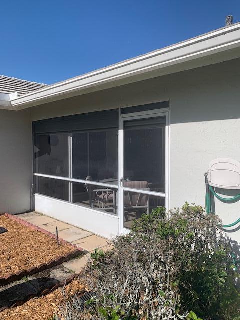 view of side of home featuring a sunroom