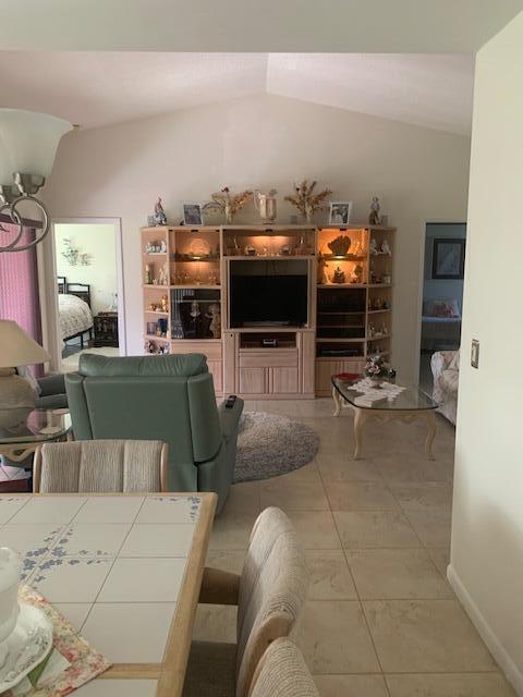 tiled living room with vaulted ceiling