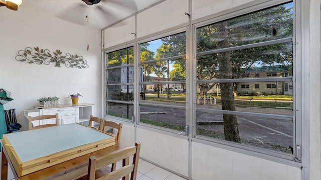 tiled dining area with ceiling fan