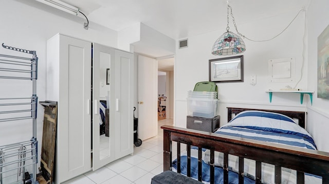 tiled bedroom with radiator heating unit and electric panel