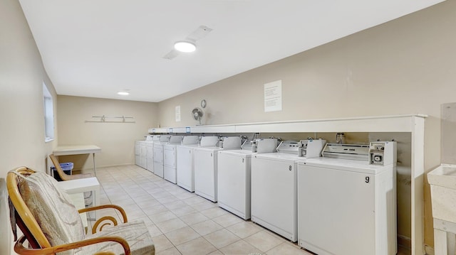 laundry area featuring washing machine and dryer and light tile patterned floors