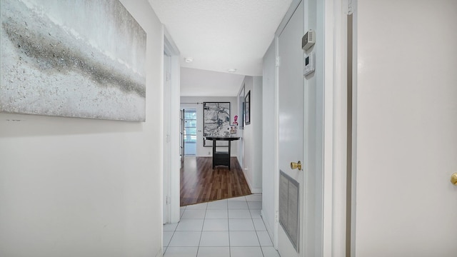 corridor with light tile patterned flooring