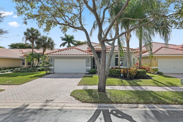 view of front of property with a garage and a front lawn