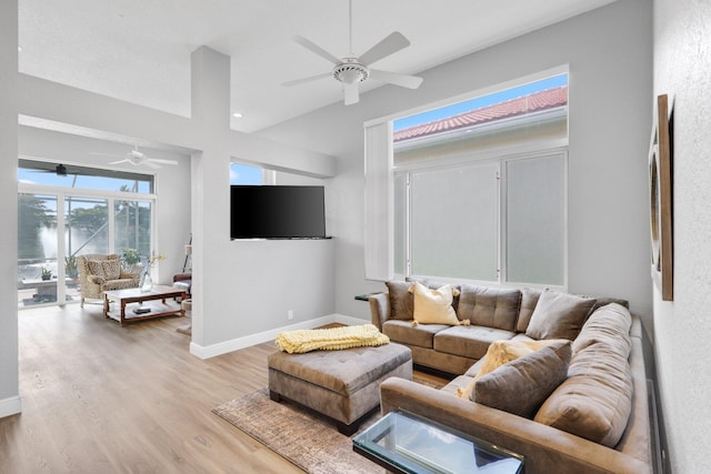 living room featuring light hardwood / wood-style floors and ceiling fan