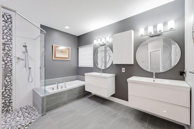 bathroom featuring tile patterned flooring, vanity, and separate shower and tub