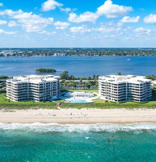 birds eye view of property with a view of the beach and a water view