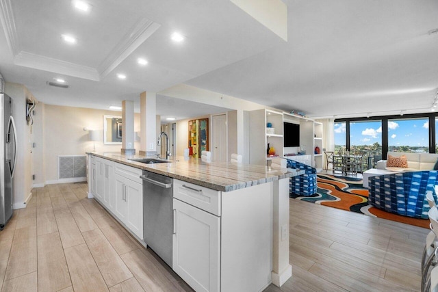 kitchen featuring sink, light stone counters, a center island with sink, appliances with stainless steel finishes, and white cabinets