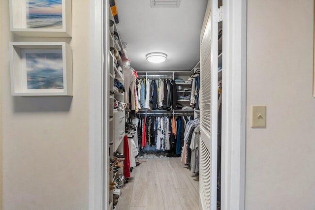 spacious closet with hardwood / wood-style flooring