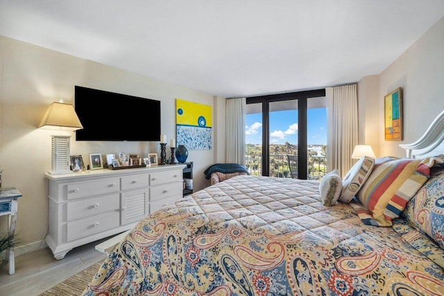 bedroom featuring floor to ceiling windows and access to outside