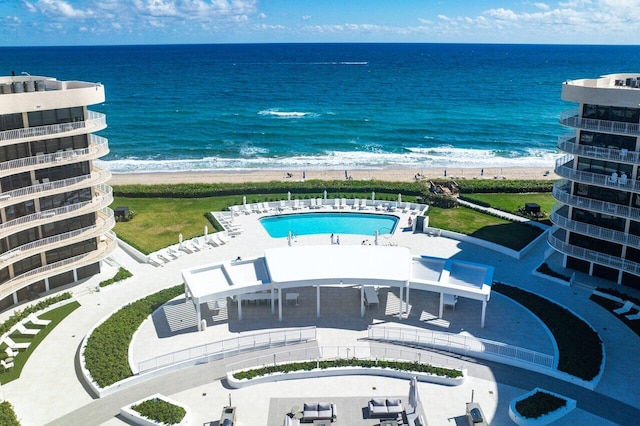 bird's eye view with a water view and a beach view