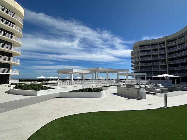 view of home's community with a patio and an outdoor hangout area