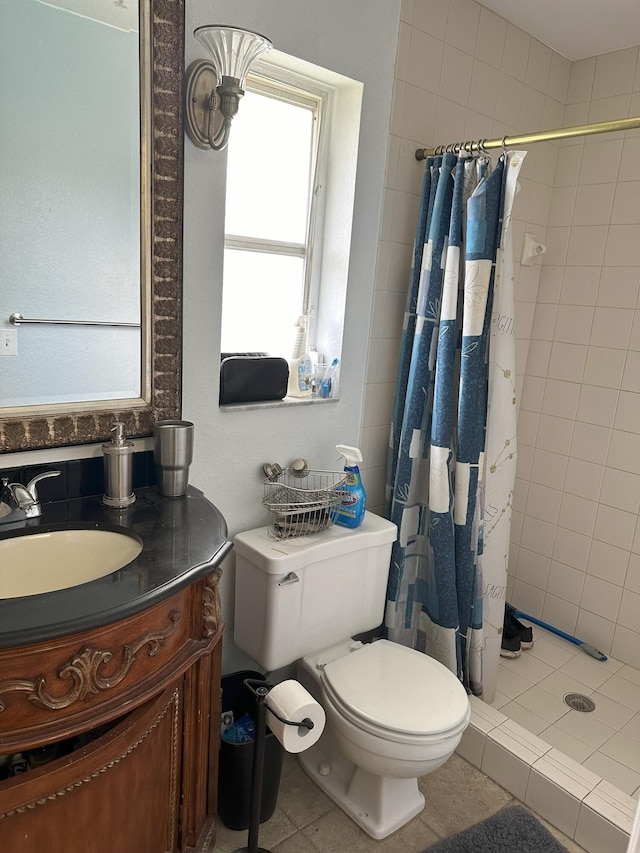 bathroom featuring vanity, curtained shower, tile patterned floors, and toilet