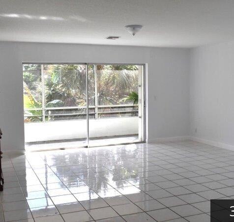 tiled spare room with a healthy amount of sunlight