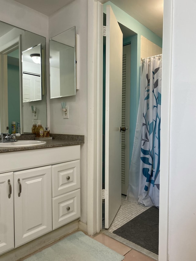 bathroom with tile patterned floors, vanity, and curtained shower