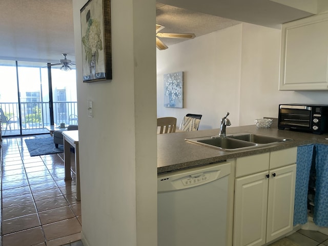 kitchen featuring sink, ceiling fan, white cabinetry, floor to ceiling windows, and white dishwasher