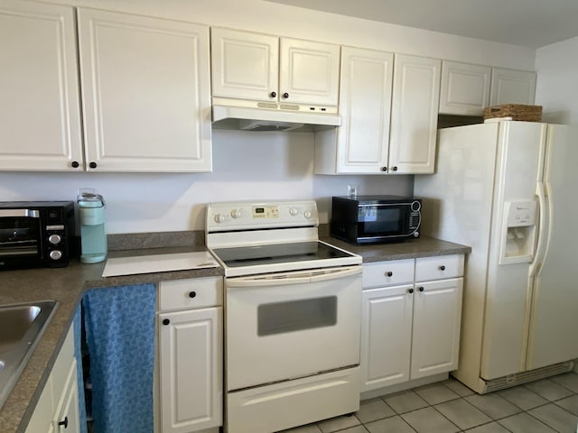 kitchen featuring white cabinetry and white appliances