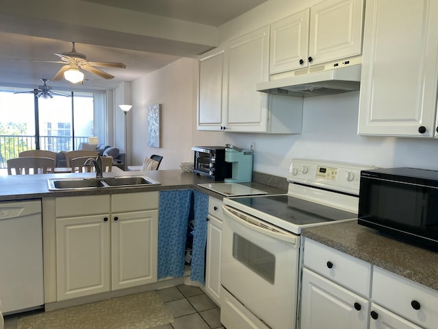 kitchen with light tile patterned floors, sink, white appliances, white cabinets, and kitchen peninsula