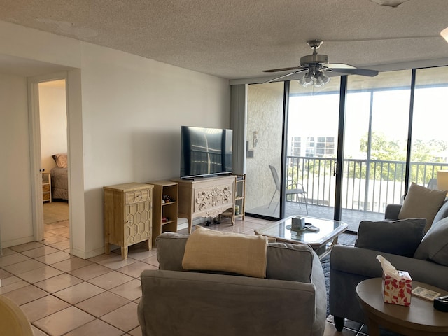 living room with floor to ceiling windows, light tile patterned floors, ceiling fan, and a textured ceiling