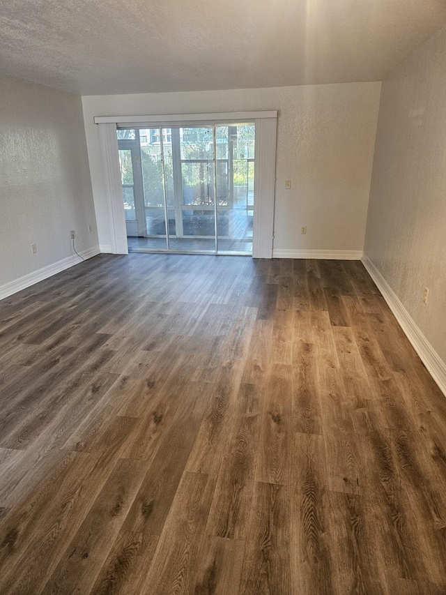 spare room featuring dark hardwood / wood-style flooring