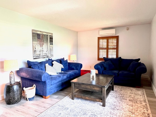 living room with wood-type flooring and a wall unit AC