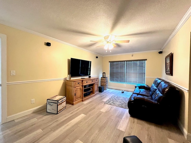 living room with ornamental molding, light wood-type flooring, ceiling fan, and a textured ceiling