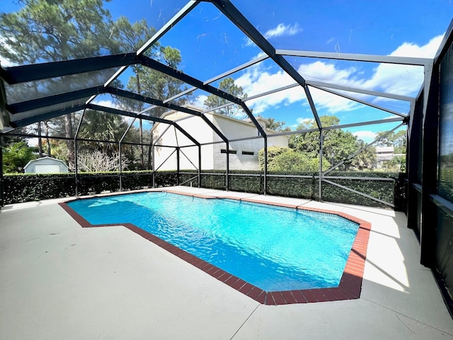 view of swimming pool featuring a lanai and a patio area